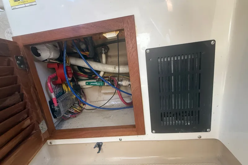 Slide: The Image of Electrical compartment of a 2012 Ranger Tugs R-21 EC boat, showing wiring and components. - 36