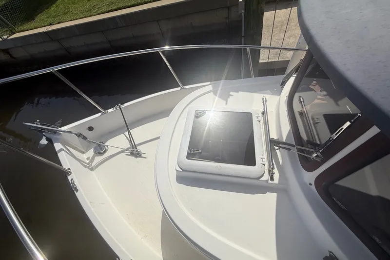 Slide: The Image of 2012 Ranger Tugs R-21 EC boat deck with open hatch and railing. - 48