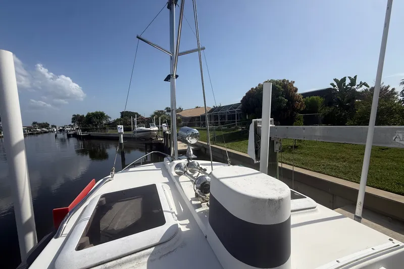 Slide: The Image of 2012 Ranger Tugs R-21 EC docked by a serene waterfront, under a clear blue sky. - 47