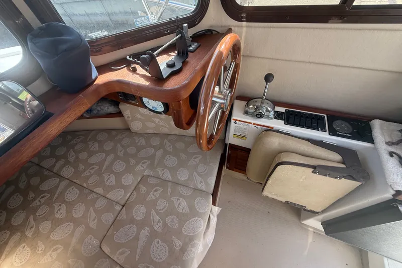 Slide: The Image of Interior of 2012 Ranger Tugs R-21 EC with wooden helm and nautical controls. - 17