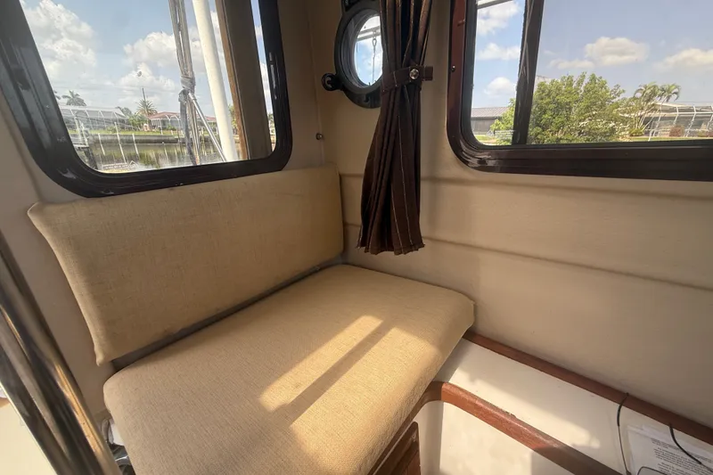 Slide: The Image of Cozy interior seating of 2012 Ranger Tugs R-21 EC boat with window view. - 25