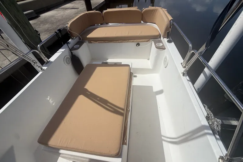 Slide: The Image of 2012 Ranger Tugs R-21 EC boat interior with beige cushioned seating. - 4