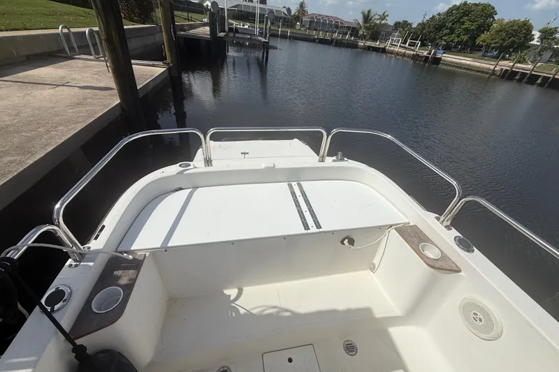 Slide: The Image of 2012 Ranger Tugs R-21 EC boat docked in a calm marina setting. - 7