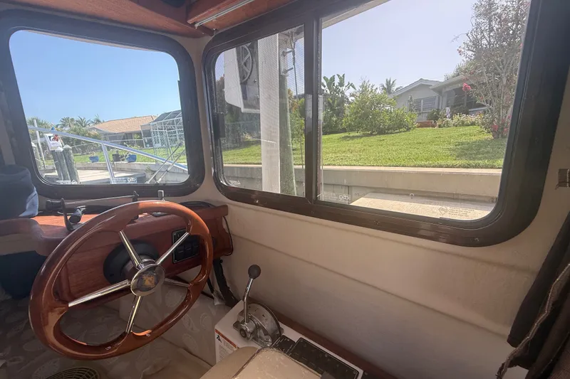 Slide: The Image of Interior view of 2012 Ranger Tugs R-21 EC boat with wooden steering wheel. - 18