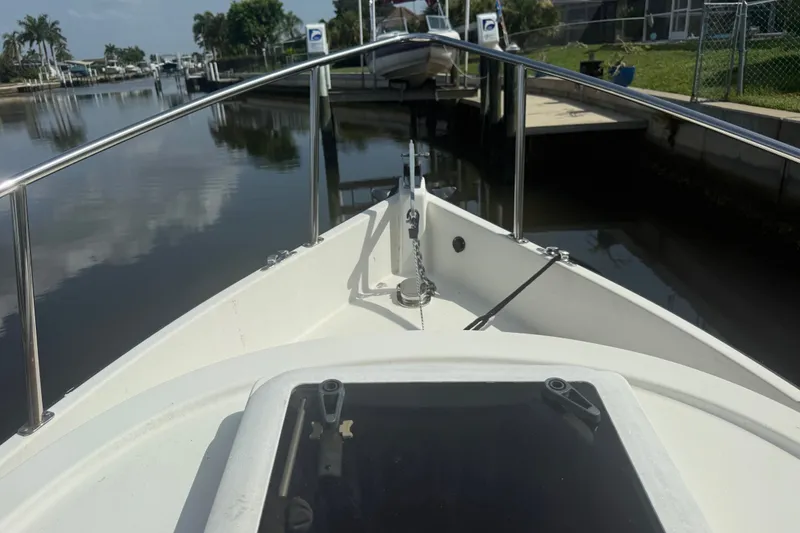 Slide: The Image of Bow view of 2012 Ranger Tugs R-21 EC boat docked in a calm marina. - 46
