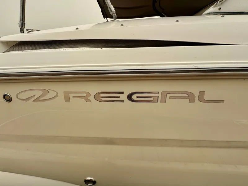 Slide: The Image of Close-up of the "Regal" logo on a boat hull. - 41