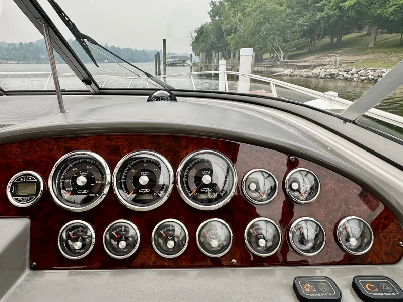 Slide: The Image of Dashboard of a 2012 Regal 3550 Cuddy with elegant wood inlays and multiple gauges. - 25