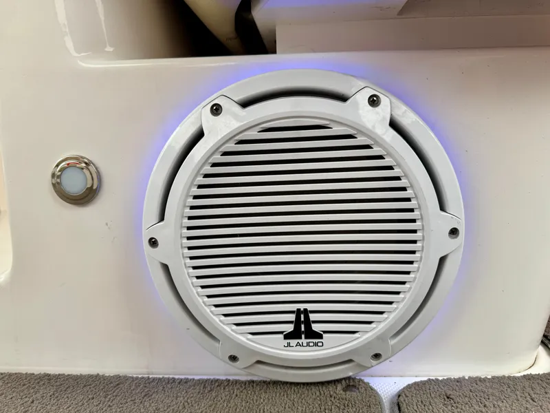 Slide: The Image of A JL Audio speaker is mounted in the white wall of a 2012 Regal 3550 Cuddy boat. - 42