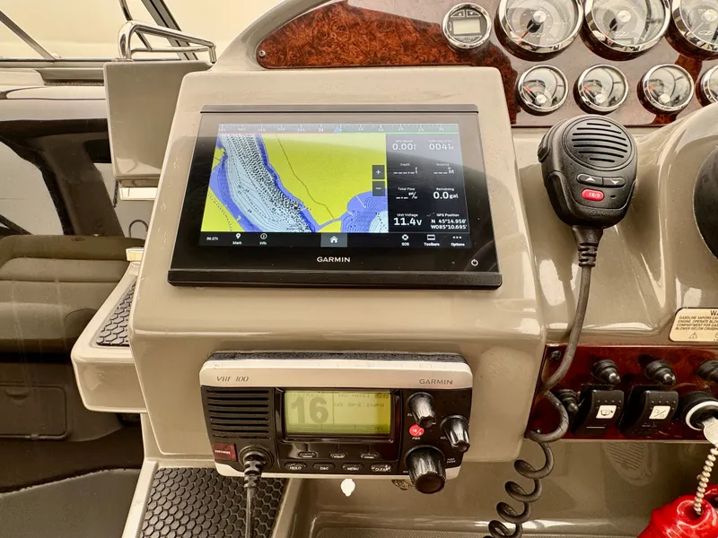 Slide: The Image of The image shows the dashboard of a 2012 Regal 3550 Cuddy with a Garmin navigation system. - 27