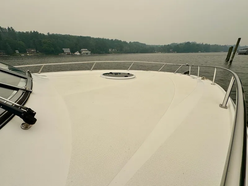 Slide: The Image of The image shows the deck of a 2012 Regal 3550 Cuddy on calm waters. - 35