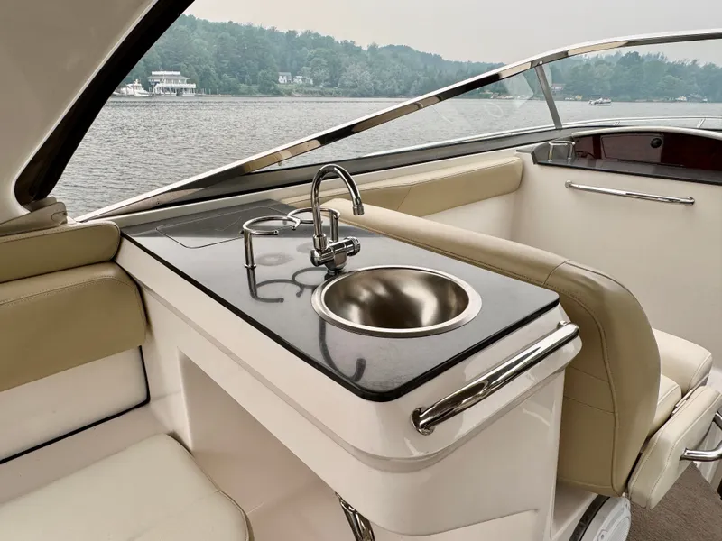 Slide: The Image of The 2012 Regal 3550 Cuddy features a sleek onboard kitchenette with a sink and faucet. - 21