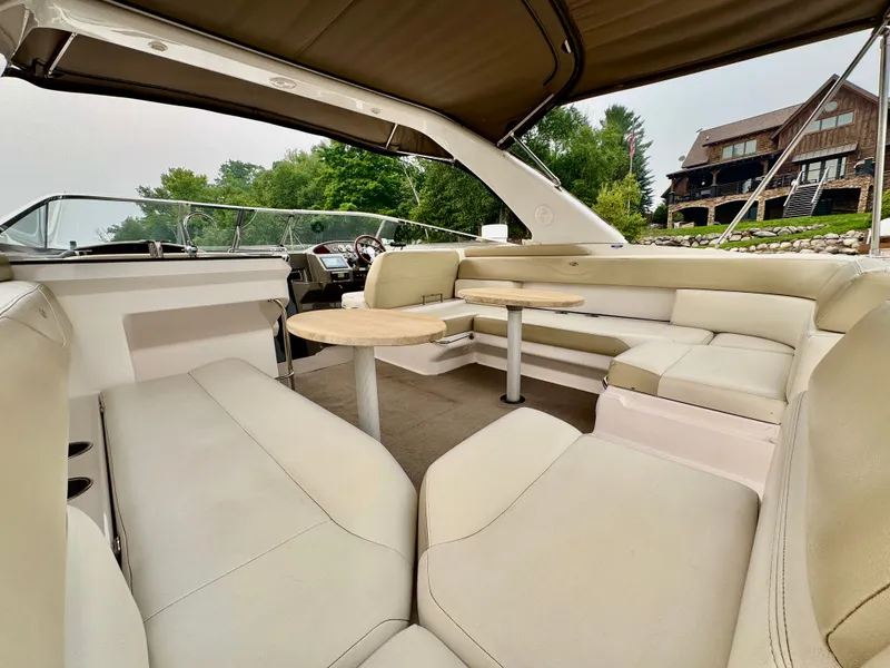 Slide: The Image of The image shows the cockpit of a 2012 Regal 3550 Cuddy with beige upholstery and a table. - 18
