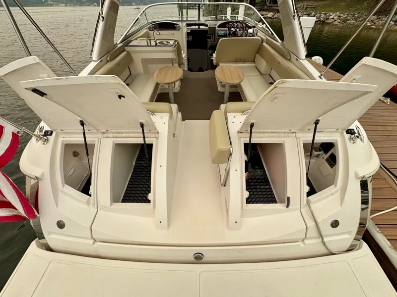 Slide: The Image of The image shows the stern of a 2012 Regal 3550 Cuddy boat with open storage compartments. - 17