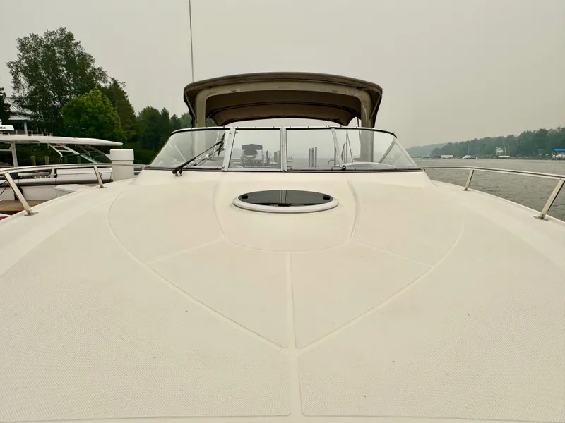 Slide: The Image of The image shows the deck of a 2012 Regal 3550 Cuddy with a closed canopy. - 38