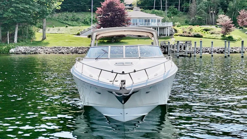 Slide: The Image of A 2012 Regal 3550 Cuddy anchored in calm waters in front of a house. - 8