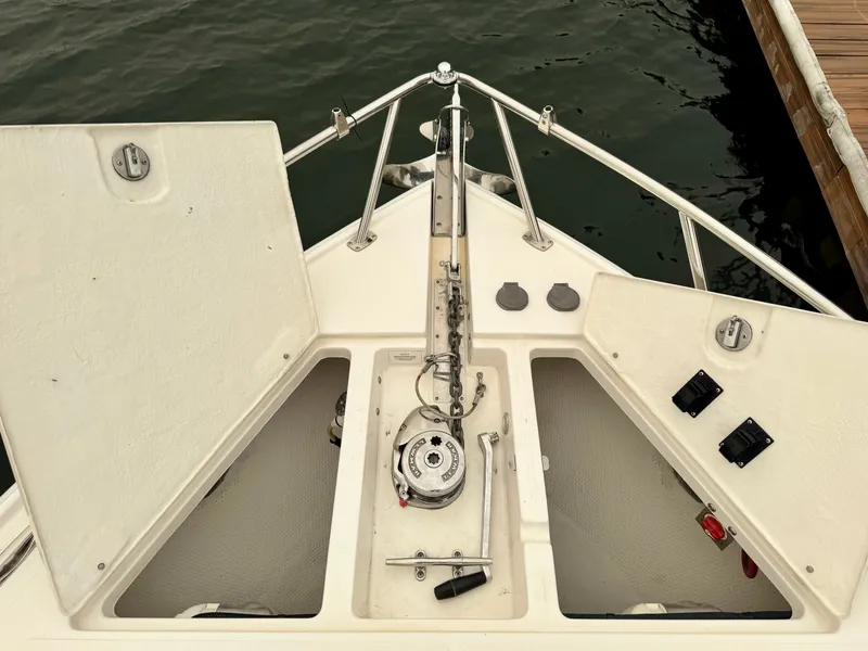 Slide: The Image of The bow of a boat with anchor windlass and storage compartments, docked beside a pier. - 37