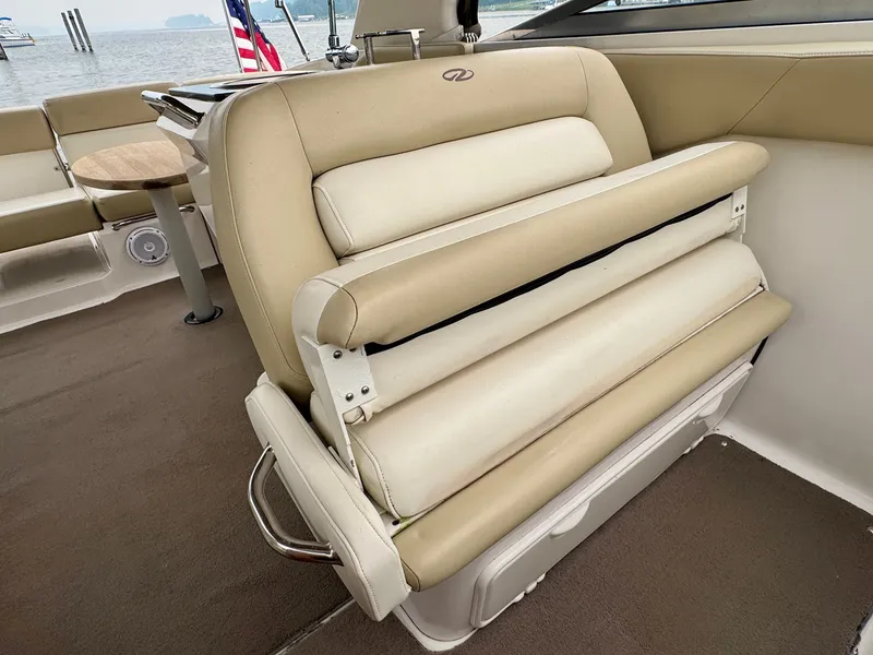Slide: The Image of The 2012 Regal 3550 Cuddy features a beige cushioned bench with an adjustable backrest. - 31