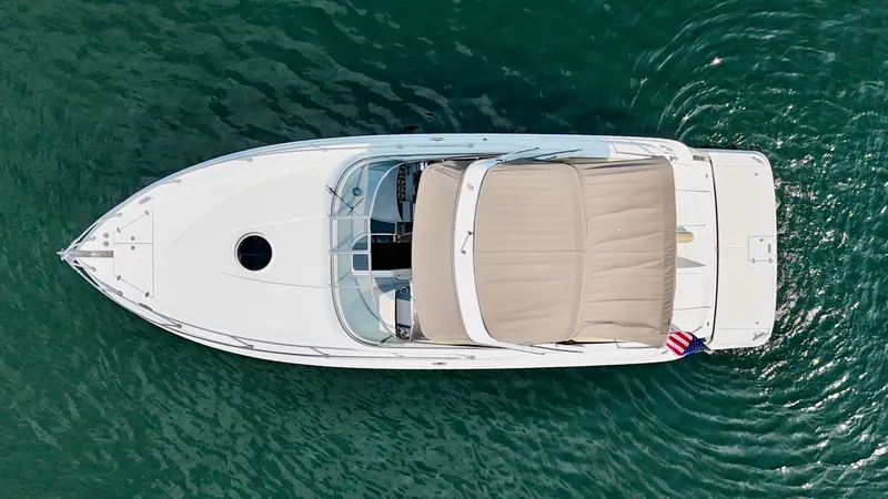 Slide: The Image of Aerial view of a white 2012 Regal 3550 Cuddy on calm water. - 12