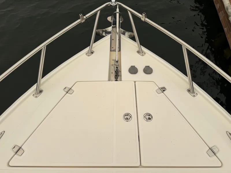 Slide: The Image of Bow view of the 2012 Regal 3550 Cuddy with stainless steel railing and anchor windlass. - 36
