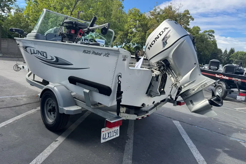 Slide: The Image of 2011 Lund 1625 Rebel XL Sport boat with Honda outboard motor on trailer. - 3
