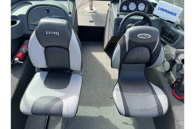 Slide: The Image of 2011 Lund 1625 Rebel XL Sport boat interior with seats and dashboard. - 6