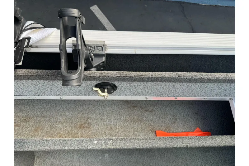 Slide: The Image of Interior view of a 2011 Lund 1625 Rebel XL Sport boat with rod holder and storage compartment. - 16