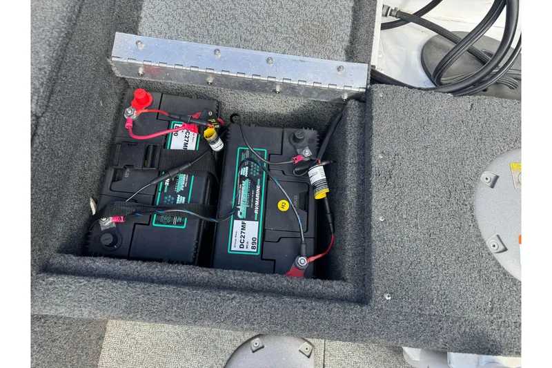 Slide: The Image of 2011 Lund 1625 Rebel XL Sport boat battery compartment with dual batteries and wiring. - 13