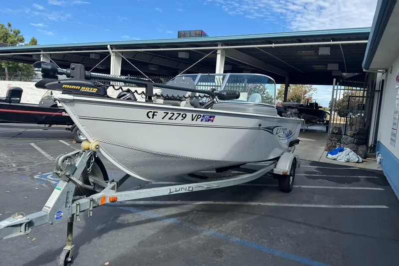Slide: The Image of 2011 Lund 1625 Rebel XL Sport boat on trailer in parking lot. - 2