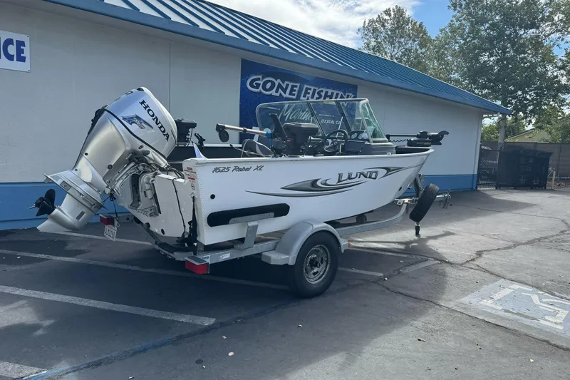 Slide: The Image of 2011 Lund 1625 Rebel XL Sport boat with Honda outboard motor on trailer. - 4