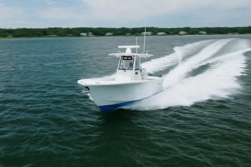 Slide: The Image of 2021 Regulator 28 Forward Seating boat cruising on open water. - 9