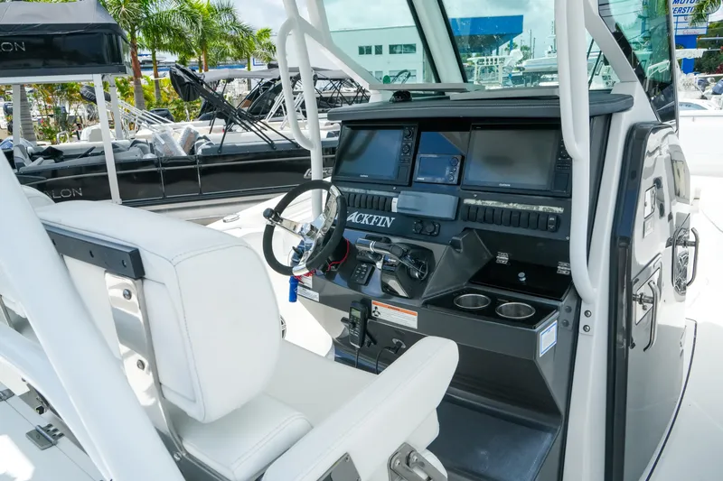 Slide: The Image of 2019 Blackfin 272 CC boat helm with modern navigation equipment and white seating. - 13