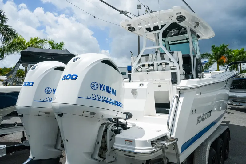 Slide: The Image of 2019 Blackfin 272 CC boat with twin Yamaha 300 engines, docked outdoors. - 9