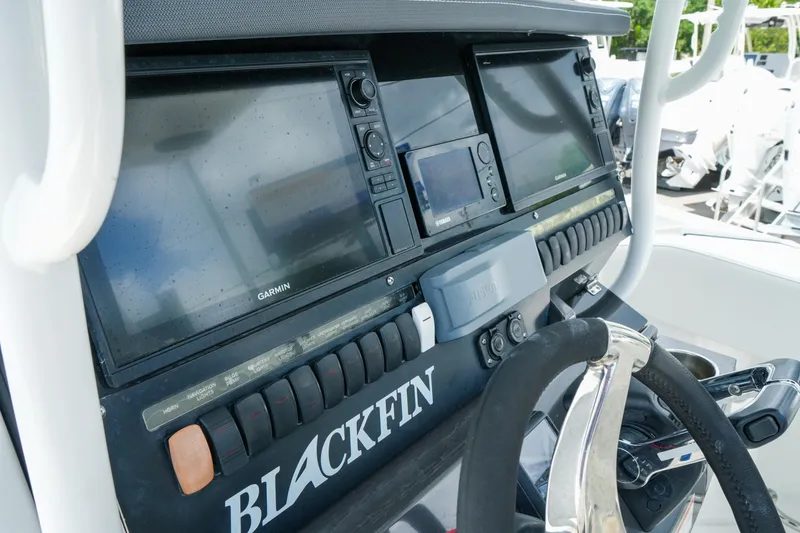 Slide: The Image of 2019 Blackfin 272 CC boat dashboard with Garmin navigation displays and steering wheel. - 17