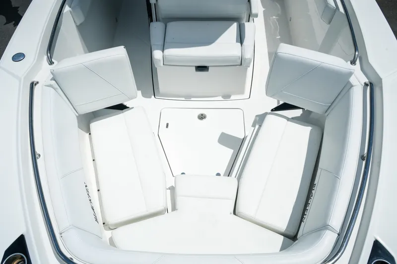 Slide: The Image of 2019 Blackfin 272 CC boat interior with white cushioned seating arrangement. - 21