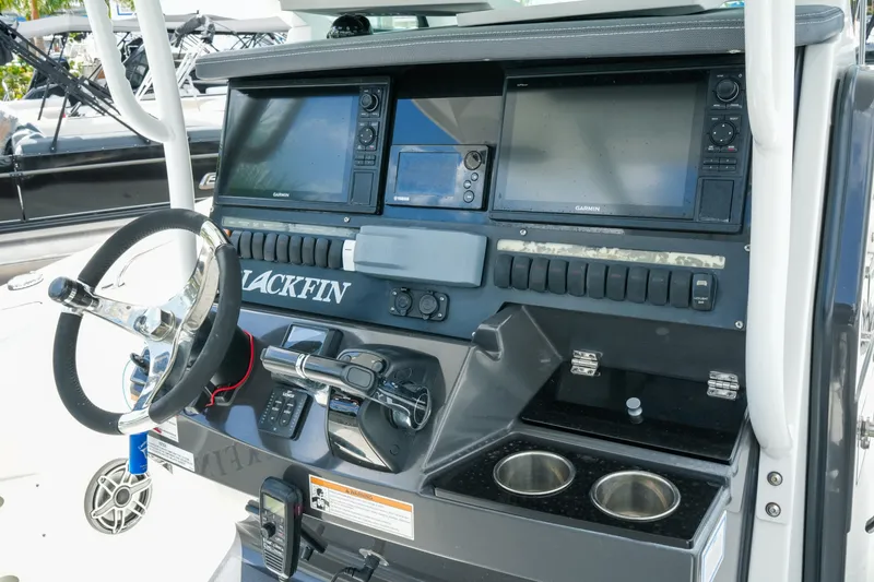 Slide: The Image of 2019 Blackfin 272 CC boat dashboard with steering wheel and navigation controls. - 14