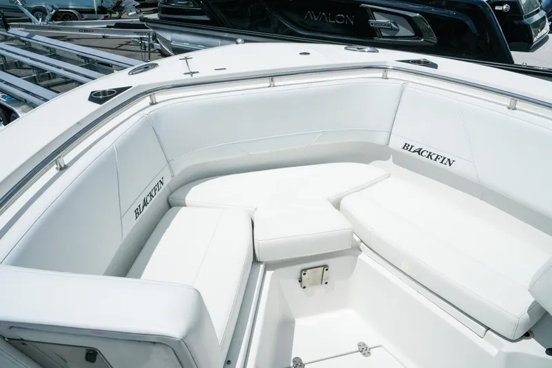 Slide: The Image of 2019 Blackfin 272 CC boat with white cushioned seating in the bow area. - 20