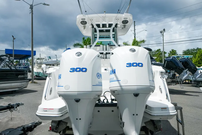 Slide: The Image of 2019 Blackfin 272 CC boat with dual Yamaha 300 engines in a marina setting. - 8