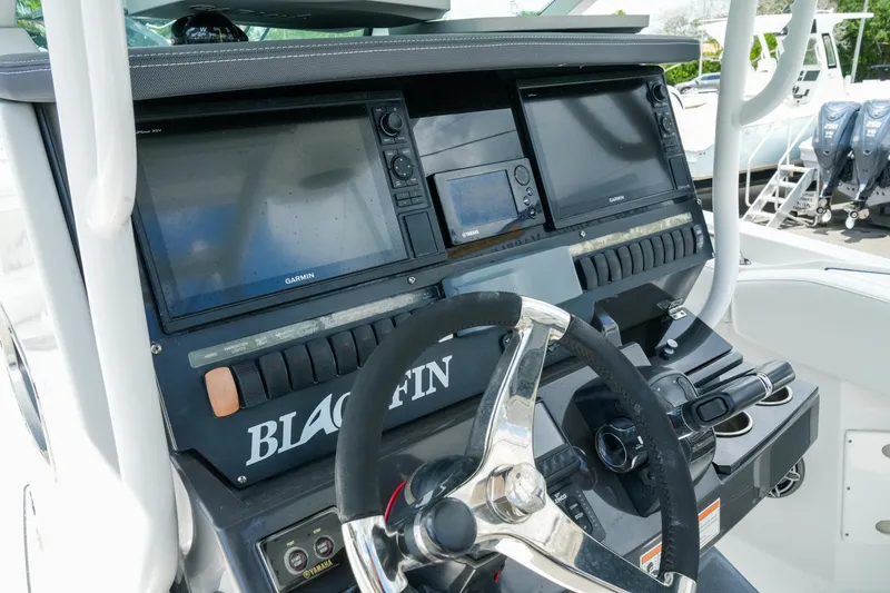 Slide: The Image of 2019 Blackfin 272 CC boat dashboard with Garmin displays and steering wheel. - 16