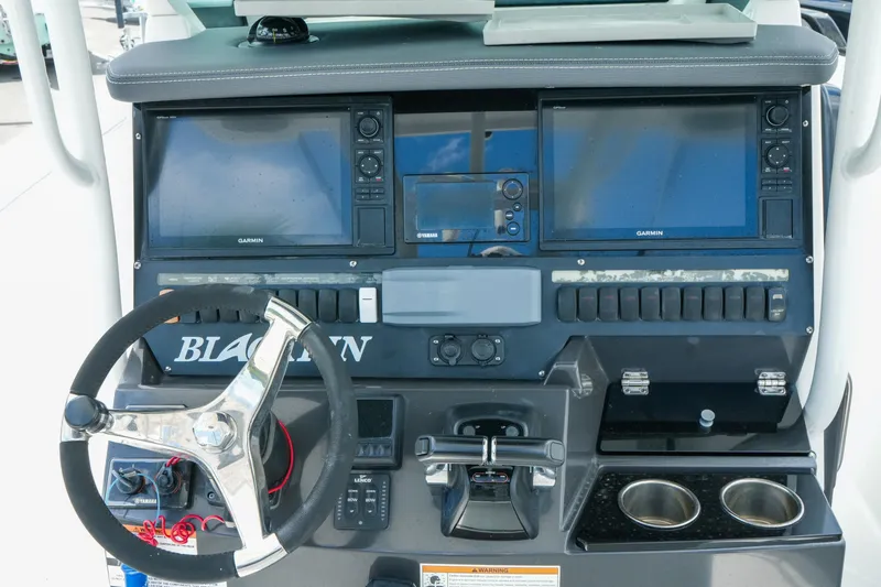 Slide: The Image of 2019 Blackfin 272 CC boat dashboard with Garmin displays and steering wheel. - 15