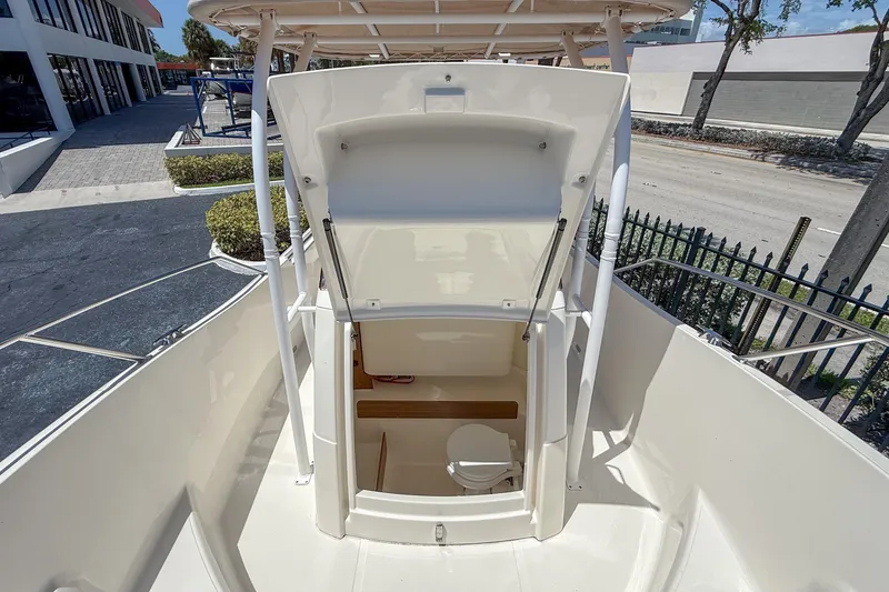 Slide: The Image of 2023 White Shark 230CC boat with open storage compartment and visible toilet. - 6