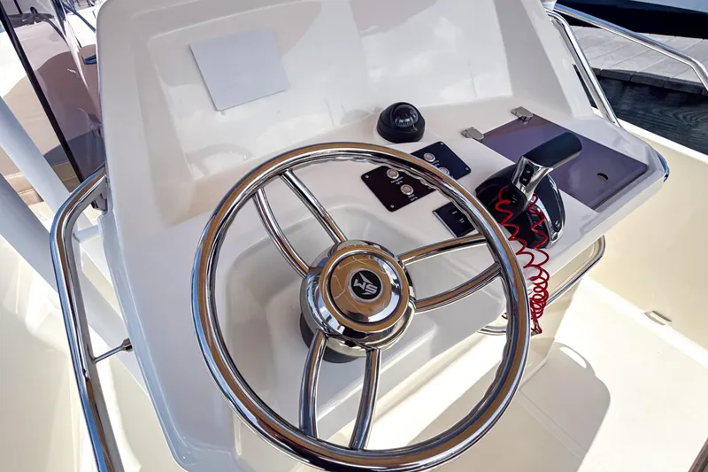 Slide: The Image of Steering console of 2023 White Shark 230CC boat with chrome wheel and controls. - 10