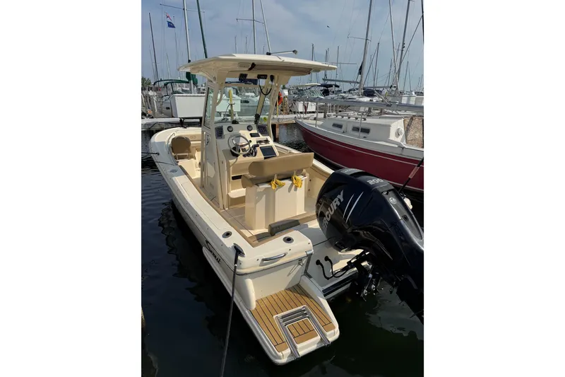 Slide: The Image of 2017 Scout 215 XSF boat docked, featuring a Mercury outboard motor. - 4