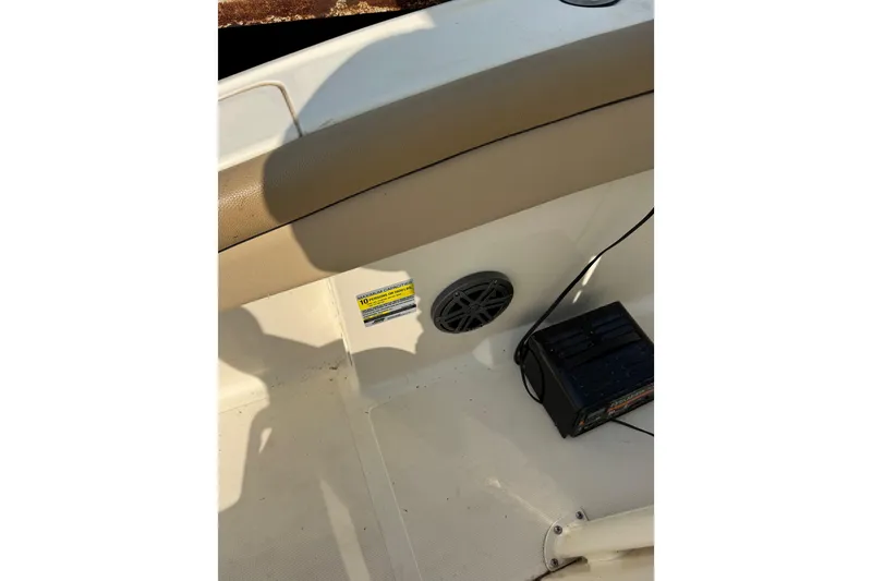 Slide: The Image of Interior of 2017 Scout 215 XSF boat showing speaker and battery on deck. - 12