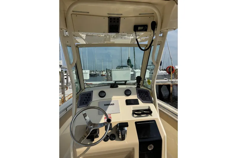 Slide: The Image of 2017 Scout 215 XSF boat dashboard with steering wheel and navigation equipment. - 5