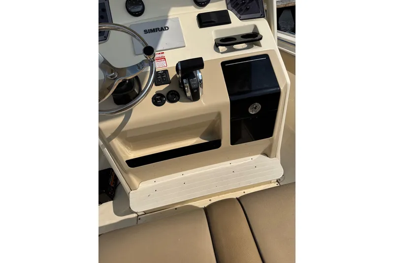 Slide: The Image of 2017 Scout 215 XSF boat dashboard with steering wheel and controls. - 7