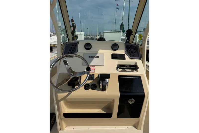 Slide: The Image of 2017 Scout 215 XSF boat dashboard with steering wheel and Simrad navigation system. - 6