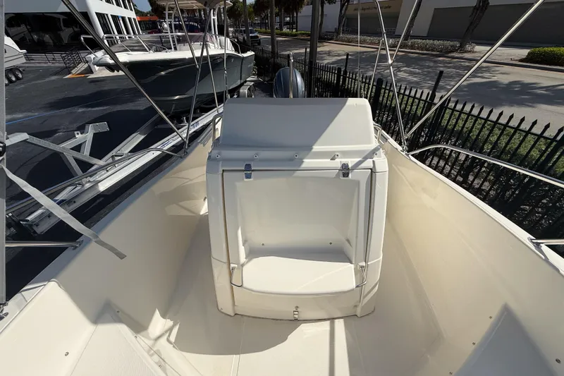 Slide: The Image of 2023 White Shark 210CC boat interior, showcasing seating and helm area. - 3