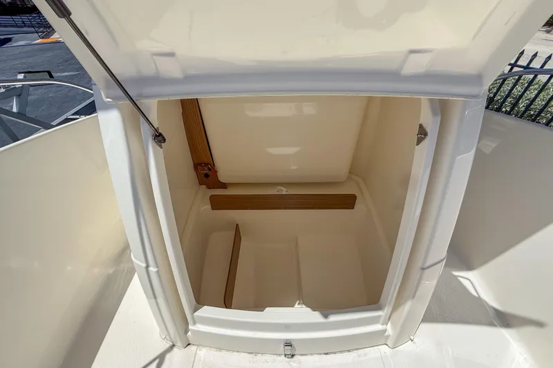 Slide: The Image of 2023 White Shark 210CC boat storage compartment, open and empty, showcasing interior space. - 5