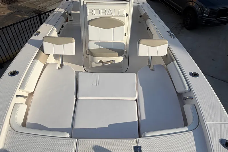 Slide: The Image of 2018 Robalo 246 Cayman boat interior with cushioned seating and sleek design. - 18