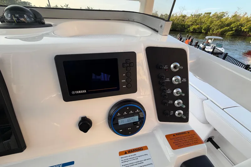 Slide: The Image of Control panel of a 2018 Robalo 246 Cayman boat with Yamaha display and switches. - 30